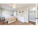 Comfortable bedroom with ceiling fan, white dresser, and multiple entry doors at 311 S 6Th Ave, Beech Grove, IN 46107