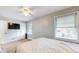 Bedroom with ceiling fan, large windows, and a wall-mounted television at 311 S 6Th Ave, Beech Grove, IN 46107