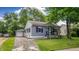 Charming house with a well-manicured lawn and a detached garage, offering a blend of comfort and convenience at 311 S 6Th Ave, Beech Grove, IN 46107
