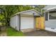 Detached one-car garage with white door and wooden gate at 311 S 6Th Ave, Beech Grove, IN 46107