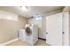 Basement laundry room with a full-sized washer and dryer set and window, offering convenience and functionality at 311 S 6Th Ave, Beech Grove, IN 46107