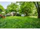 Back yard with play set, storage shed, and mature trees at 33 N Webster Ave, Indianapolis, IN 46219