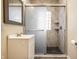 Bathroom featuring modern vanity, with sliding glass shower doors and tiled walls at 33 N Webster Ave, Indianapolis, IN 46219