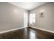 Bedroom featuring dark hardwood floors, neutral walls, and a window at 33 N Webster Ave, Indianapolis, IN 46219