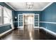 Elegant dining room with hardwood floors, bright windows, and french doors at 33 N Webster Ave, Indianapolis, IN 46219