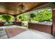 Inviting covered front porch with brick accents, hanging ferns, and porch swing at 33 N Webster Ave, Indianapolis, IN 46219