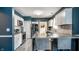 Modern kitchen with stainless steel appliances, white cabinets, and breakfast bar at 33 N Webster Ave, Indianapolis, IN 46219