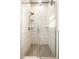 Shower stall featuring glass doors, subway tile walls, and tiled floor at 33 N Webster Ave, Indianapolis, IN 46219