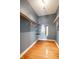 Walk-in closet with hardwood flooring, shelving, hanging racks and a mirror at 33 N Webster Ave, Indianapolis, IN 46219