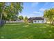 Expansive backyard featuring a lush lawn, privacy fence, and a covered patio perfect for outdoor entertaining at 3365 Riverside Dr, Columbus, IN 47203