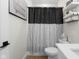 Bright bathroom with a vanity with a white countertop, toilet, and decorative accents on floating shelves at 3365 Riverside Dr, Columbus, IN 47203
