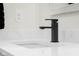 Close-up of a modern bathroom sink with white countertop and sleek black faucet at 3365 Riverside Dr, Columbus, IN 47203
