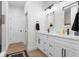 Modern bathroom with double vanity, white cabinetry, and dark fixtures at 3365 Riverside Dr, Columbus, IN 47203
