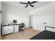 Clean bedroom features neutral walls, light wood floors, a ceiling fan, and a closet with double doors at 3365 Riverside Dr, Columbus, IN 47203