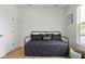 Stylish bedroom features neutral walls, light wood floors, a black daybed, and ample natural light at 3365 Riverside Dr, Columbus, IN 47203