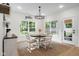 Bright breakfast nook with a wooden table set, decorative chandelier, and natural light from the backyard view at 3365 Riverside Dr, Columbus, IN 47203