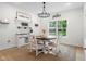 Cozy breakfast nook with rustic wood table, white chairs, and natural light at 3365 Riverside Dr, Columbus, IN 47203