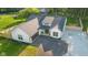 Aerial view of a charming single-Gathering home with a dark asphalt driveway and a two-car garage at 3365 Riverside Dr, Columbus, IN 47203
