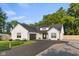 Charming home featuring modern farmhouse style, a black asphalt driveway, and a lush green lawn at 3365 Riverside Dr, Columbus, IN 47203