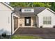 This exterior shot showcases a stone entryway, modern garage door, and beautifully landscaped surroundings at 3365 Riverside Dr, Columbus, IN 47203
