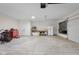 Spacious garage with an organized tool area, workbench, storage, and ample open space for parking at 3365 Riverside Dr, Columbus, IN 47203
