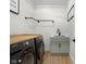 Modern laundry room features black front-load machines, wood countertop, light green cabinets, and black hardware at 3365 Riverside Dr, Columbus, IN 47203