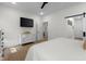 Well-lit main bedroom with minimalist decor, white dresser, and wood-look flooring at 3365 Riverside Dr, Columbus, IN 47203