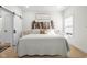 Bright main bedroom with a decorative wood accent wall and comfortable white bedding at 3365 Riverside Dr, Columbus, IN 47203