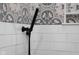 Close-up of decorative shower with gray patterned tile and matte black hardware at 3365 Riverside Dr, Columbus, IN 47203