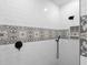 Bright and modern bathroom shower with black fixtures and decorative tile at 3365 Riverside Dr, Columbus, IN 47203