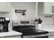 Stainless steel stove with pot filler and shaker cabinets and light countertops at 3365 Riverside Dr, Columbus, IN 47203