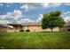 Brick home's rear exterior, showcasing a covered patio and a spacious backyard at 3717 Bellmore Dr, Brownsburg, IN 46112