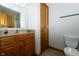 Bathroom featuring a wood vanity, tile floors, toilet and a large mirror at 3717 Bellmore Dr, Brownsburg, IN 46112