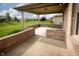 Relaxing covered patio area with brick half-walls, perfect for outdoor entertaining at 3717 Bellmore Dr, Brownsburg, IN 46112