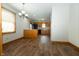 Open concept dining room featuring hardwood floors and a view into the kitchen at 3717 Bellmore Dr, Brownsburg, IN 46112