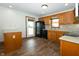 Well-lit kitchen featuring wood cabinets, black appliances, and wood flooring at 3717 Bellmore Dr, Brownsburg, IN 46112