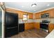 Spacious kitchen featuring wood cabinets, stainless appliances, and wood flooring at 3717 Bellmore Dr, Brownsburg, IN 46112