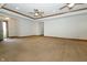 Open-concept living room showcasing natural light, neutral carpets, and tray ceilings at 3717 Bellmore Dr, Brownsburg, IN 46112