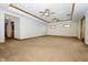 Spacious living room featuring neutral carpet, tray ceilings, and ample natural light at 3717 Bellmore Dr, Brownsburg, IN 46112