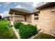 Sideyard view of the home, showing the covered patio and manicured landscaping at 3717 Bellmore Dr, Brownsburg, IN 46112