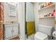 Cozy bathroom with unique brick wall, stylish vanity, ample shelving, and a shower with a curtain at 379 N Marion St, Morgantown, IN 46160