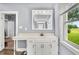 Full bathroom with a vanity and large mirror. View through the window lets in plenty of natural light at 379 N Marion St, Morgantown, IN 46160