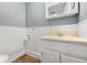 Bathroom featuring white vanity, cabinet storage, and linoleum flooring at 379 N Marion St, Morgantown, IN 46160