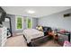 This cozy bedroom offers natural light with two windows, neutral carpet, and a classic, cottage design at 379 N Marion St, Morgantown, IN 46160