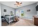 Bright bedroom featuring two windows, a ceiling fan, and a comfortable bed at 379 N Marion St, Morgantown, IN 46160