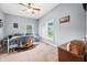 Well-lit bedroom with large windows, ceiling fan and white metal bed frame at 379 N Marion St, Morgantown, IN 46160