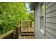 Wooden deck with railings and steps, surrounded by trees at 379 N Marion St, Morgantown, IN 46160