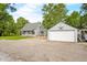 Quaint home with detached garage and large parking area, surrounded by lush greenery at 379 N Marion St, Morgantown, IN 46160
