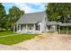 Cozy home featuring a covered porch and adjacent covered patio at 379 N Marion St, Morgantown, IN 46160