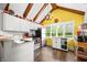 Eat-in kitchen with white cabinetry, modern appliances, and wood floors at 379 N Marion St, Morgantown, IN 46160